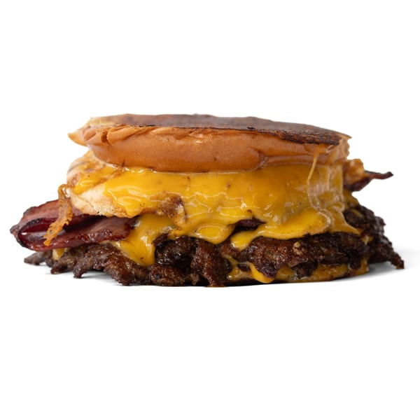 A double smash burger with melted cheese and bacon on a toasted bun.
