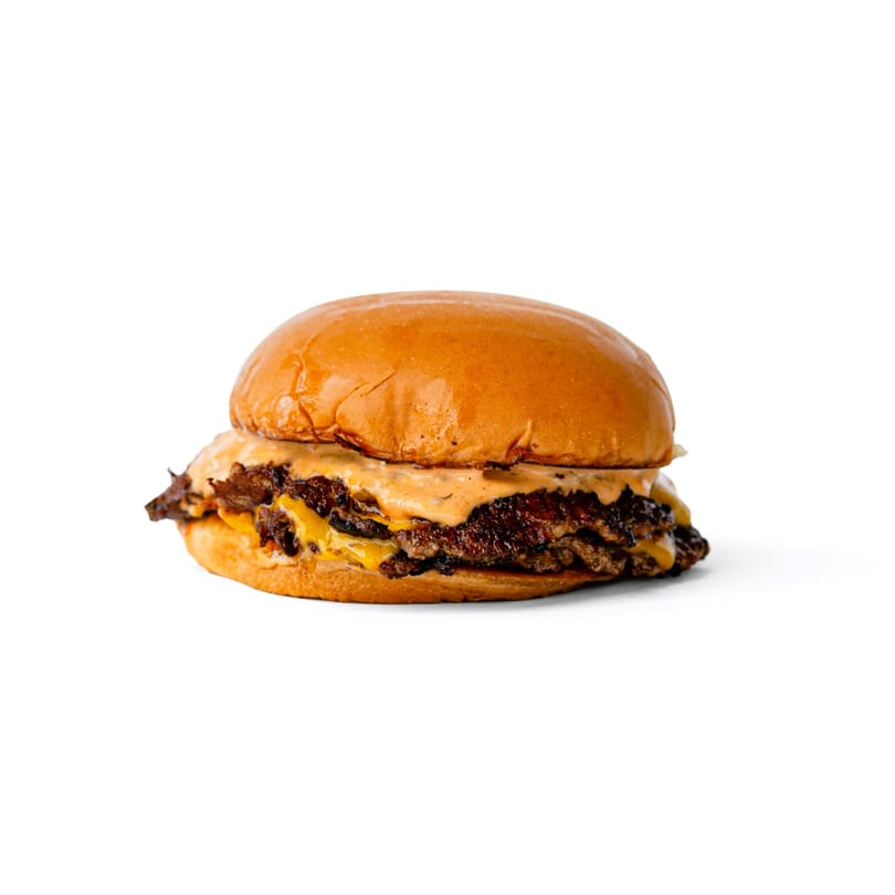A double smash burger with melted cheese and special sauce on a brioche bun.