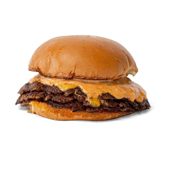 A double smash burger with melted cheese and special sauce on a toasted bun.